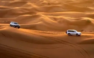 Abu Dhabi Sunset Desert Safari with BBQ, Camel Ride & Sandboarding